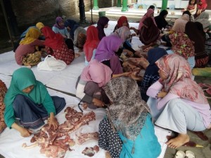 santri berbaur dengan masyarakat memotong daging qurban